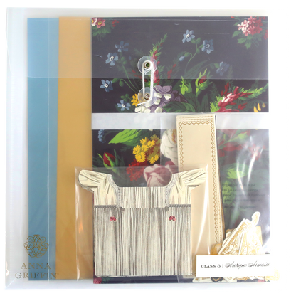 An Antique Armoire Class Materials and Dies adorned with a delicate flower and a custom card.