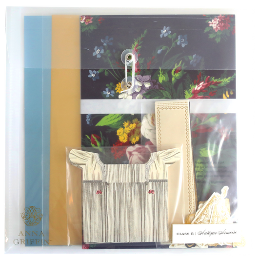 An Antique Armoire Class Materials and Dies adorned with a delicate flower and a custom card.