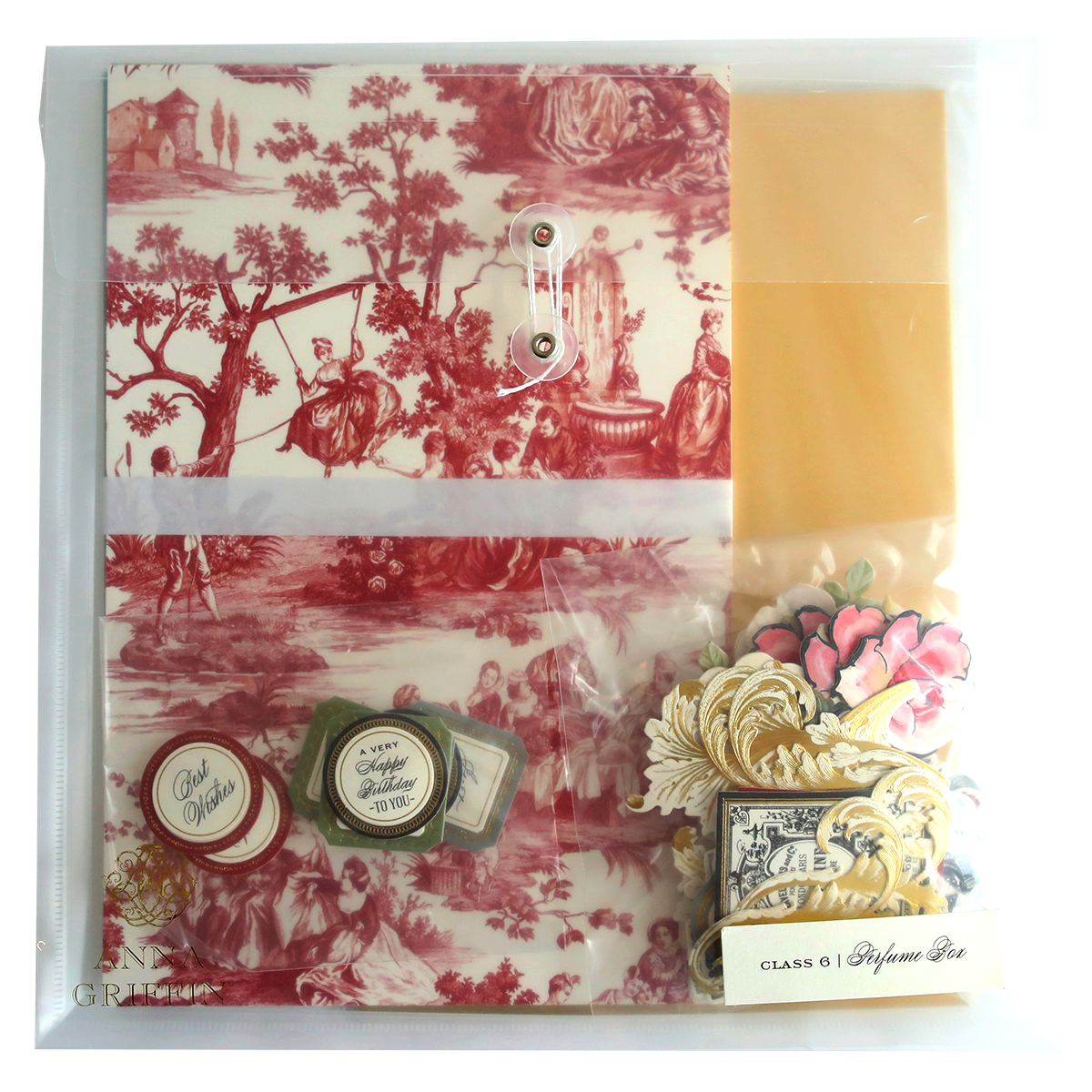 A Perfume Box Class Materials and Dies with a red and white toile paper, containing a stamp.