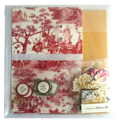 A Perfume Box Class Materials and Dies with a red and white toile paper, containing a stamp.