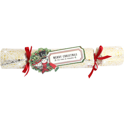 The Holiday Crackers Dies make for charming Christmas table decorations with their combination of gold and white, red ribbons, and a tag that reads "Merry Christmas to you & yours." The design showcases an illustration of two snowmen in winter attire, making them perfect for holding small gifts.