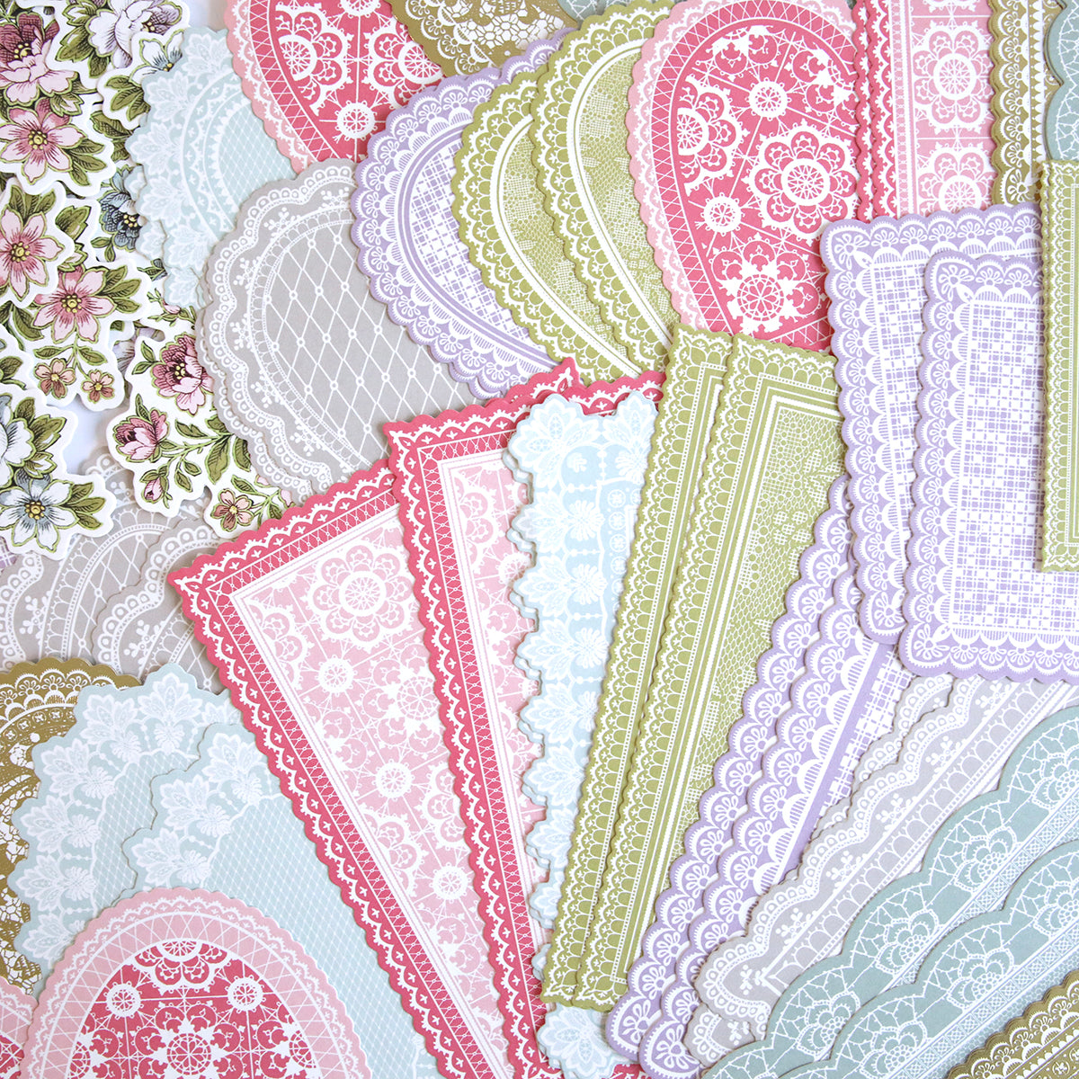 A pile of papers adorned with Lace Doily Embellishments.