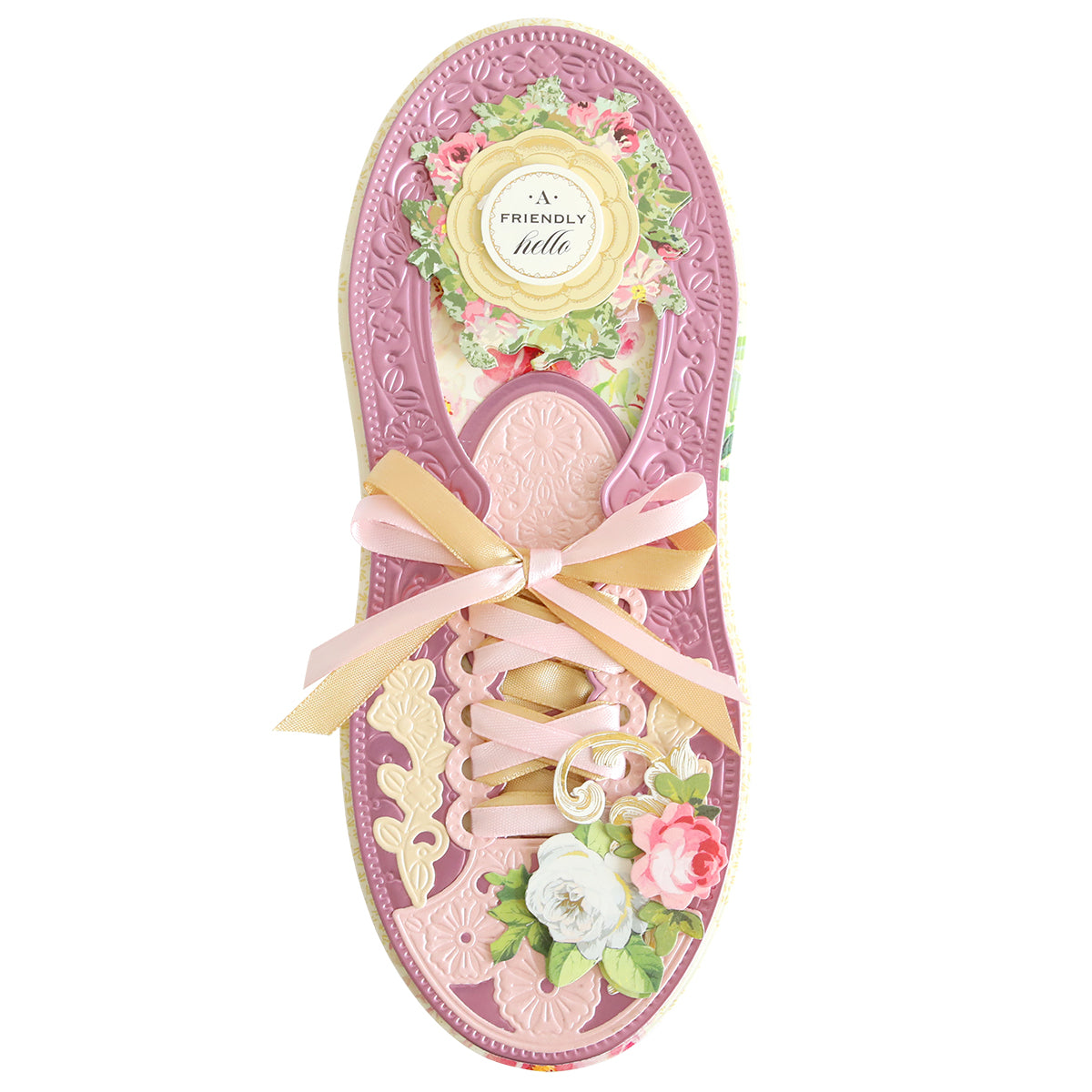 A decorative, cardboard shoe-shaped card for the true shoe lover, featuring floral patterns and a bow on the front with the text "Paper Sneaker Dies" on a circular label near the top.
