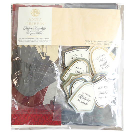 A packaged set of Paper Wingtips Refill Kit, including various folded leaf designs in grey and red, and labeled tags with phrases like "We make the perfect pair" and "Sending wishes," enhanced with 3D embellishments for an added touch of elegance.