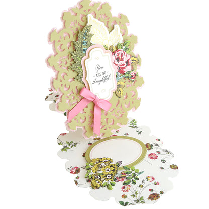 Simply Thank You Card Making Kits creates an intricate, die-cut, layered gratitude card with floral patterns, a pink ribbon, and a center tag that reads “You are so thoughtful.”