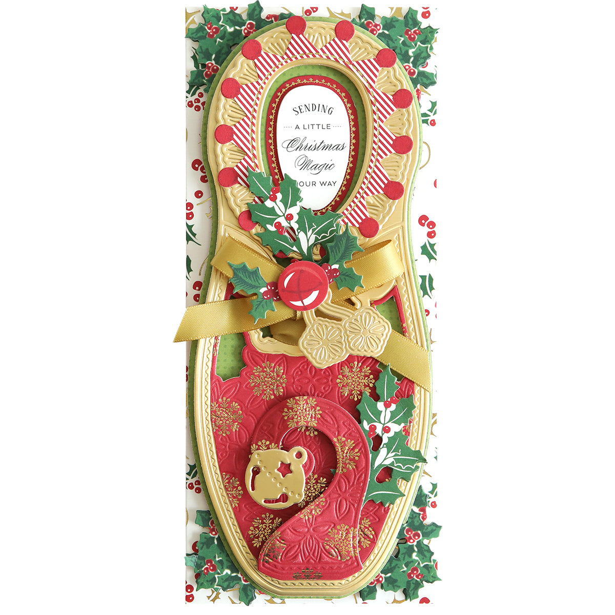 A festive Christmas card shaped like a stocking, featuring gold and red details, a bow, and holiday decorations. The card reads "Sending a little Christmas magic your way." Perfect to include with the Paper Elf Shoe Finishing School Craft Box or as an addition to any gift.