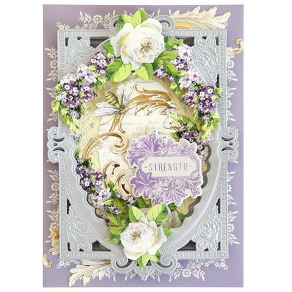 An ornate greeting card featuring a floral wreath design created with Flower Language Stamps and Dies, with white and purple flowers, and the word "strength" prominently displayed in the center on a purple label.