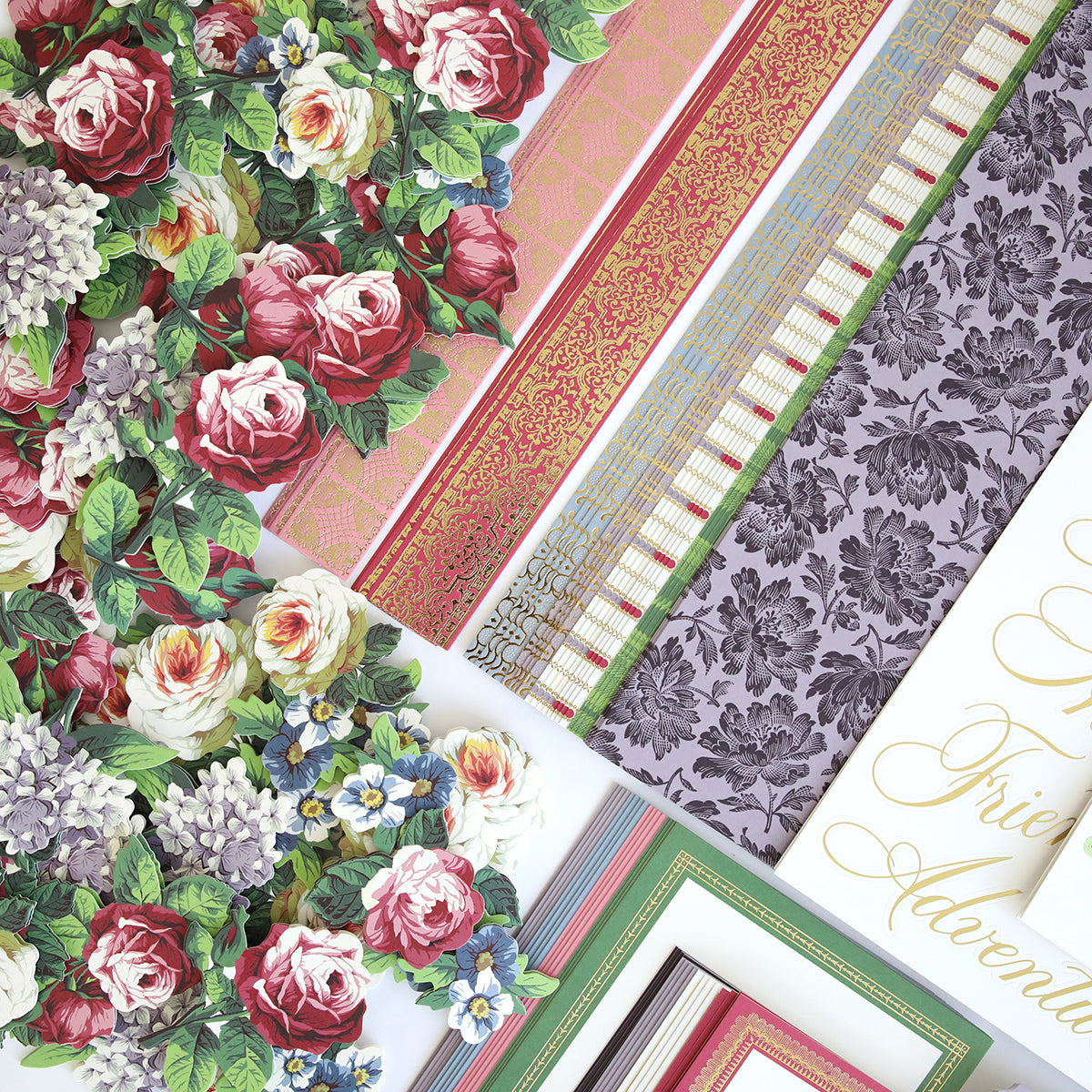 The Simply Astrid Scrapbooking Kit features an exquisite collection of assorted floral and patterned paper in various colors and textures, showcasing roses, hydrangeas, and intricate designs all neatly arranged.