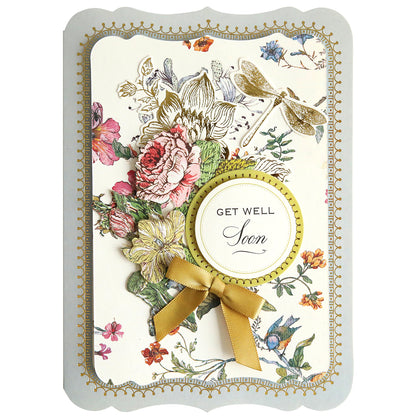 A "get well soon" handmade card adorned with floral and butterfly illustrations from the Simply Wildflower Meadow Card Making Kit, featuring a yellow ribbon.
