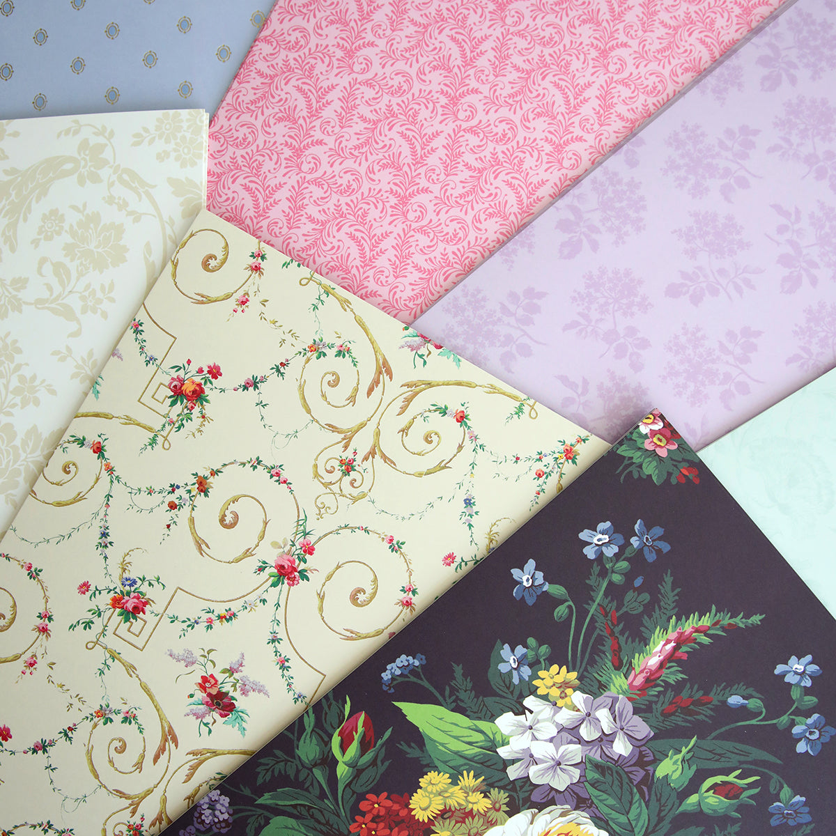 A variety of Astrid 8x12 Doublesided 300gsm Cardstock design patterned fabrics displayed side by side.