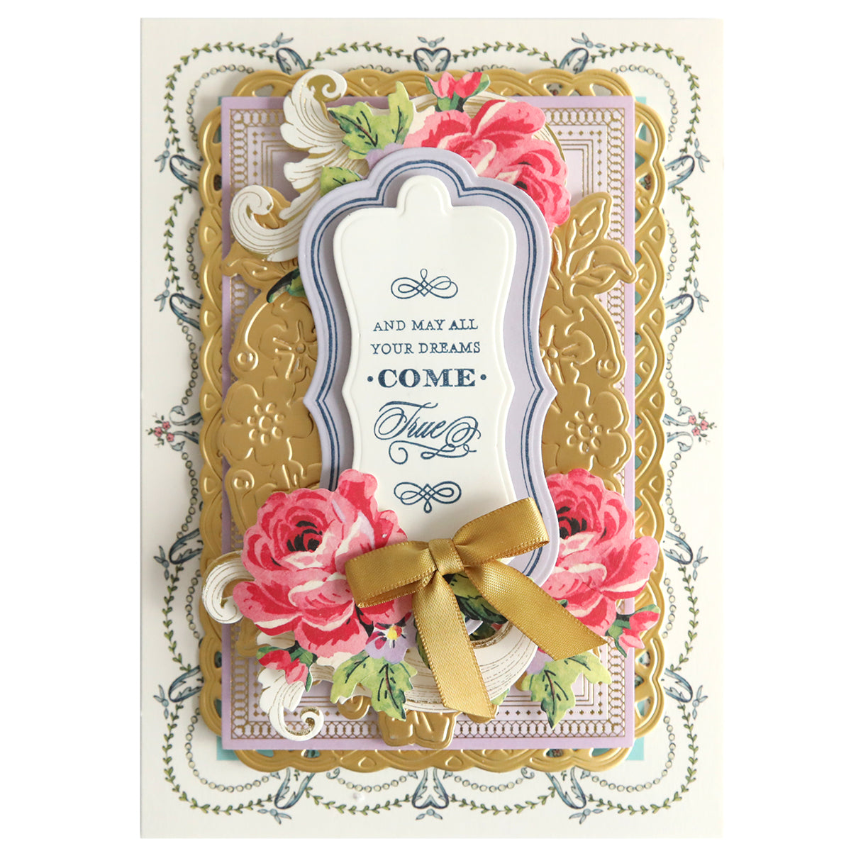 A decorative greeting card titled "Fantastic Sentiment Outline Dies" boasts a gold foil border, floral designs, and the lovely phrase "And may all your dreams come true." It is adorned with a gold ribbon bow at the bottom and enhanced by elegant sentiment stamps.