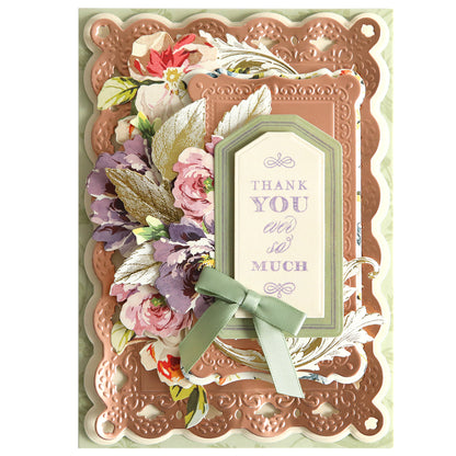 A decorative "thank you" card featuring an embossed frame, floral arrangements, and a ribbon, with elegant script text in the center using Fantastic Sentiment Stamps and Dies.