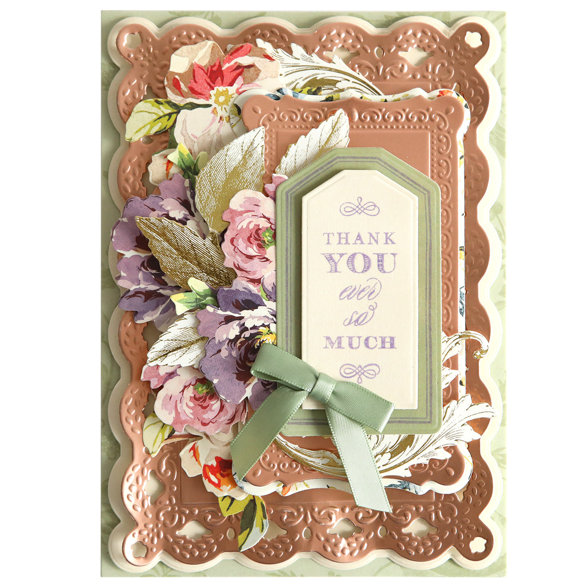 A beautifully decorated card featuring floral patterns, a green bow, gold accents, and a central tag that reads "Thank you ever so much" in purple text. The intricate diecut designs perfectly frame the sentiment, showcasing the Fantastic Sentiment Outline Dies.