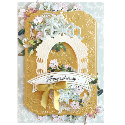 Handcrafted birthday card with a floral motif, ribbon, and a "happy birthday" banner on textured yellow background, crafted using the Card Layer Cut & Emboss Folder to add creating dimension.