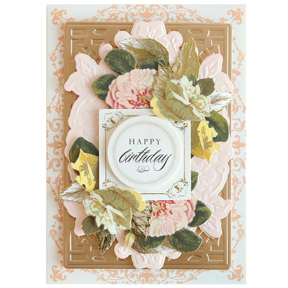 A decorative birthday card with a raised floral wreath design, created using the Card Layer Cut & Emboss Folder, surrounding a central message that reads "happy birthday" on an ornate background.