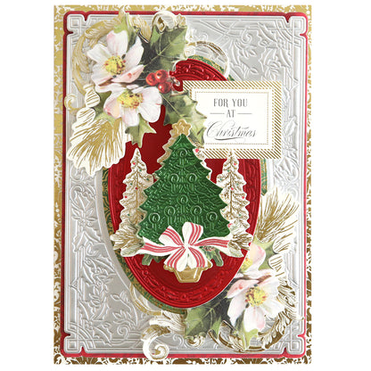 Christmas Greetings 3D Concentric Dies featuring an embossed silver background, a red oval frame, a green Christmas tree with a gold star, white flowers, and "For You at Christmas" text.