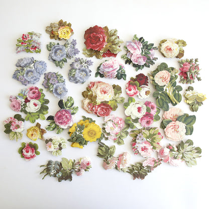 A collection of various Anniversary Floral Stickers, arranged on a white surface. The flowers are in different colors including red, pink, yellow, and purple.