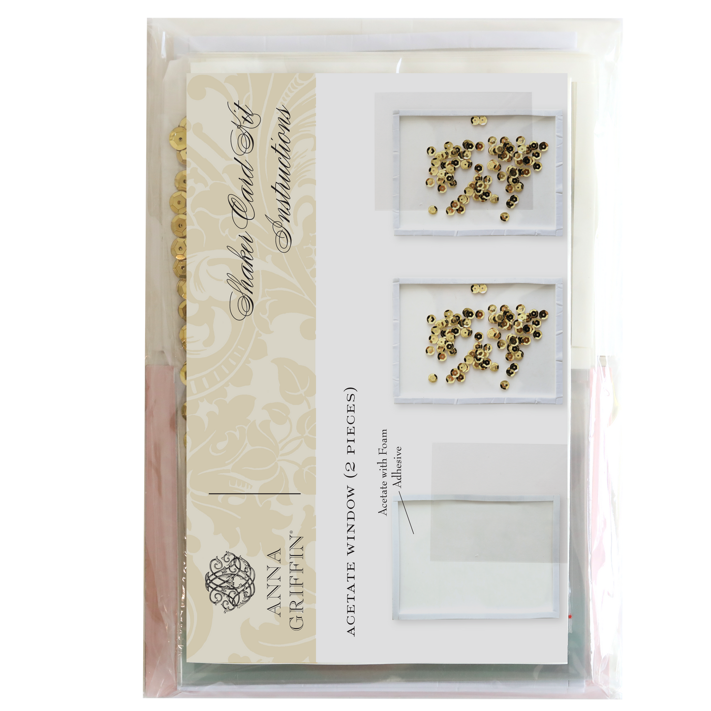 Image of the Shaker Card Supply Kit by Anna Griffin, featuring acetate windows and gold embellishments. The kit includes instructions, sequins, and materials for creating stunning shaker cards, all displayed in clear packaging.