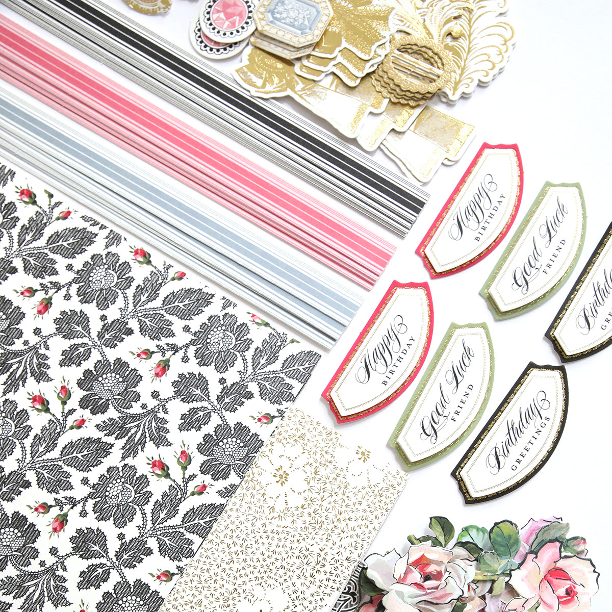 The Stylish Hats Refill Kit, featuring patterned paper, decorative cutouts, and labels with various designs, is spread out on a white surface.