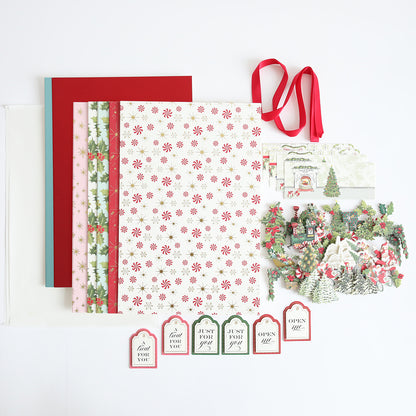 A variety of Christmas-themed items from the Treat Boxes Refill Kit, such as paper sheets, ribbons, decorative cutouts, and gift tags, displayed on a white surface.