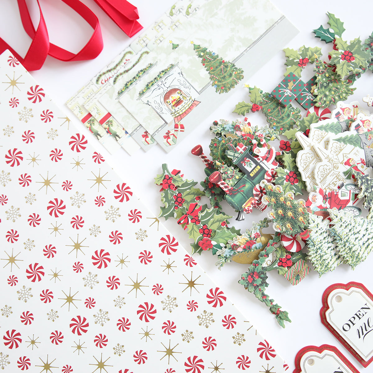 Assorted Christmas-themed supplies featuring peppermint and star design paper, along with holiday cutouts such as trees and presents from the Treat Boxes Refill Kit.