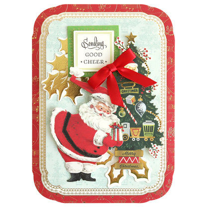 The Simply Retro Christmas Card Making Kit allows you to create a festive card featuring a Santa illustration, decorated tree, and red bow enhanced with 3D embellishments. The card includes the message "Sending Good Cheer" amidst festive motifs and gold accents, making it perfect for those seeking a touch of elegance in their holiday greetings.