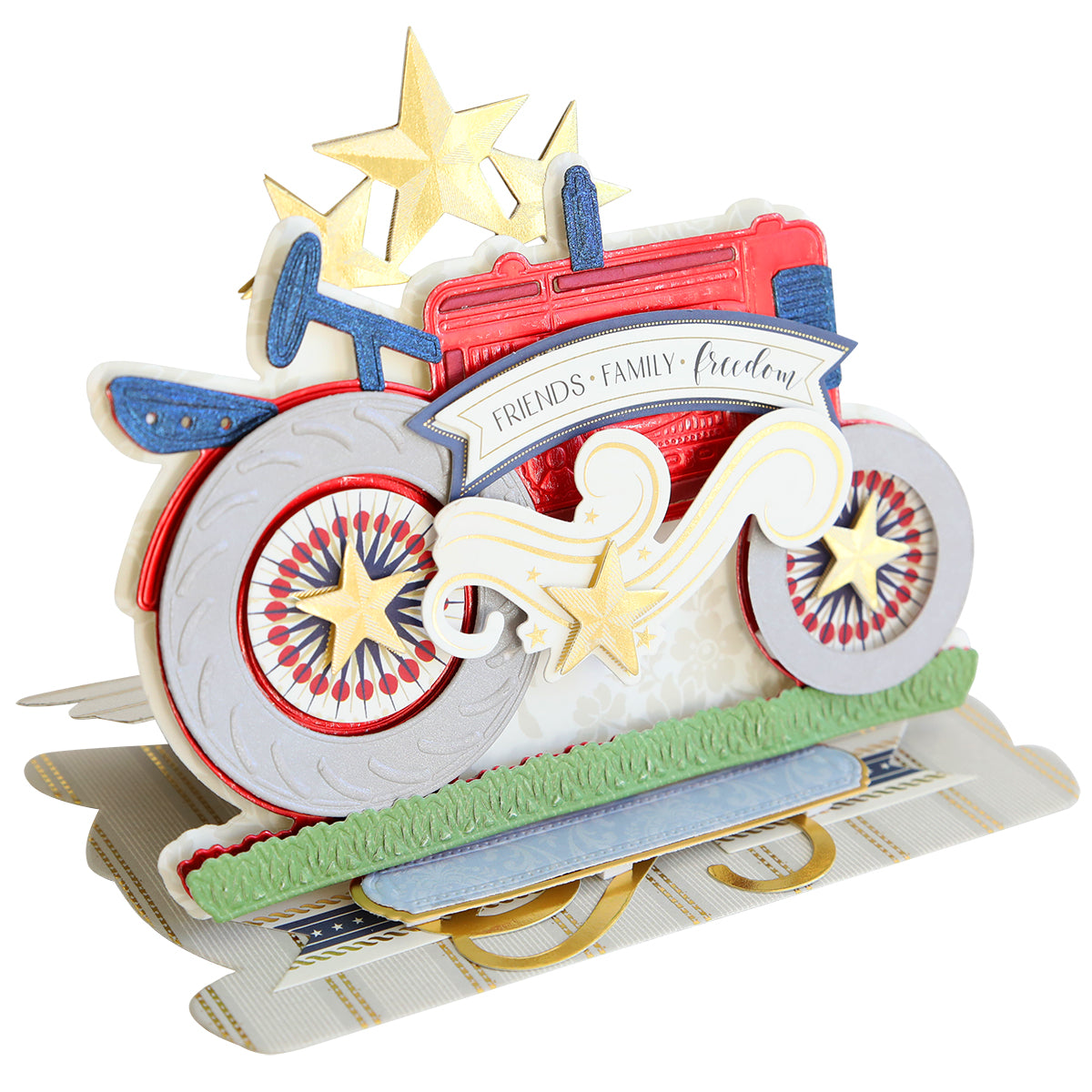 A thrilling 3D greeting card crafted using Tractor Easel Dies, showcasing a red, white, and blue bicycle adorned with stars and a banner exclaiming "Friends - Family - Freedom." The card's intricate details evoke nostalgia for farm rides while predominantly serving as a decorative piece that captures the essence of American spirit.