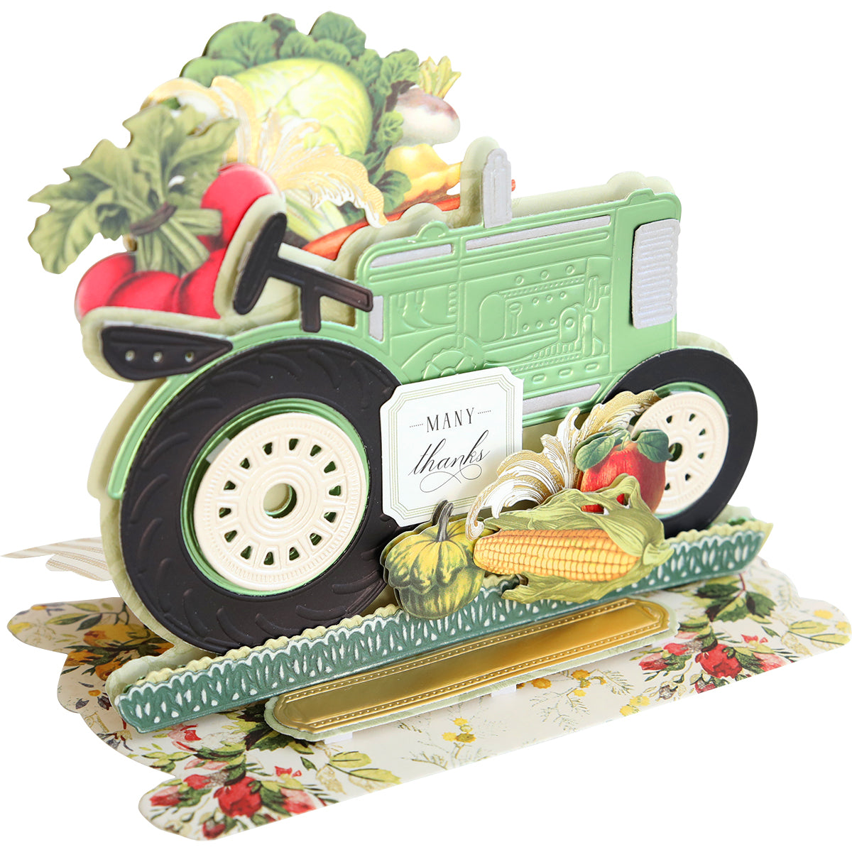 A pop-up card created with the Tractor Easel Dies, showcasing a green tractor encircled by vibrant vegetables including corn, cabbage, and radishes. The card prominently displays the text "Many thanks" along the side of the tractor, making it an ideal choice for a harvest celebration.