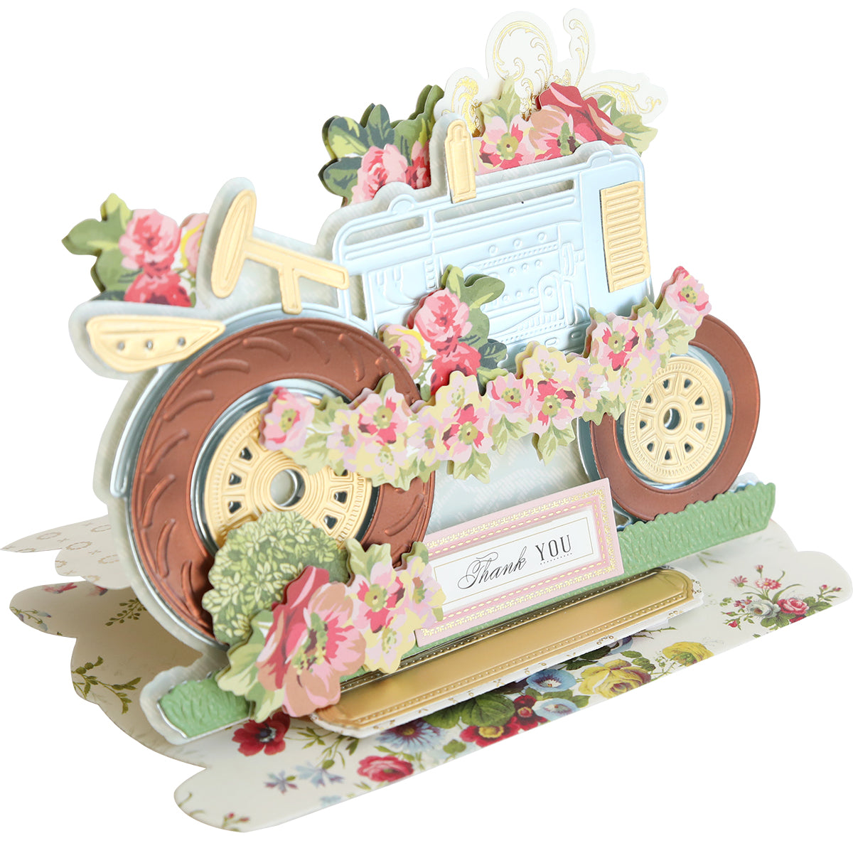 A pop-up card made using the Tractor Easel Dies, adorned with flowers and featuring the words "Thank You" at the bottom, set against a floral background.