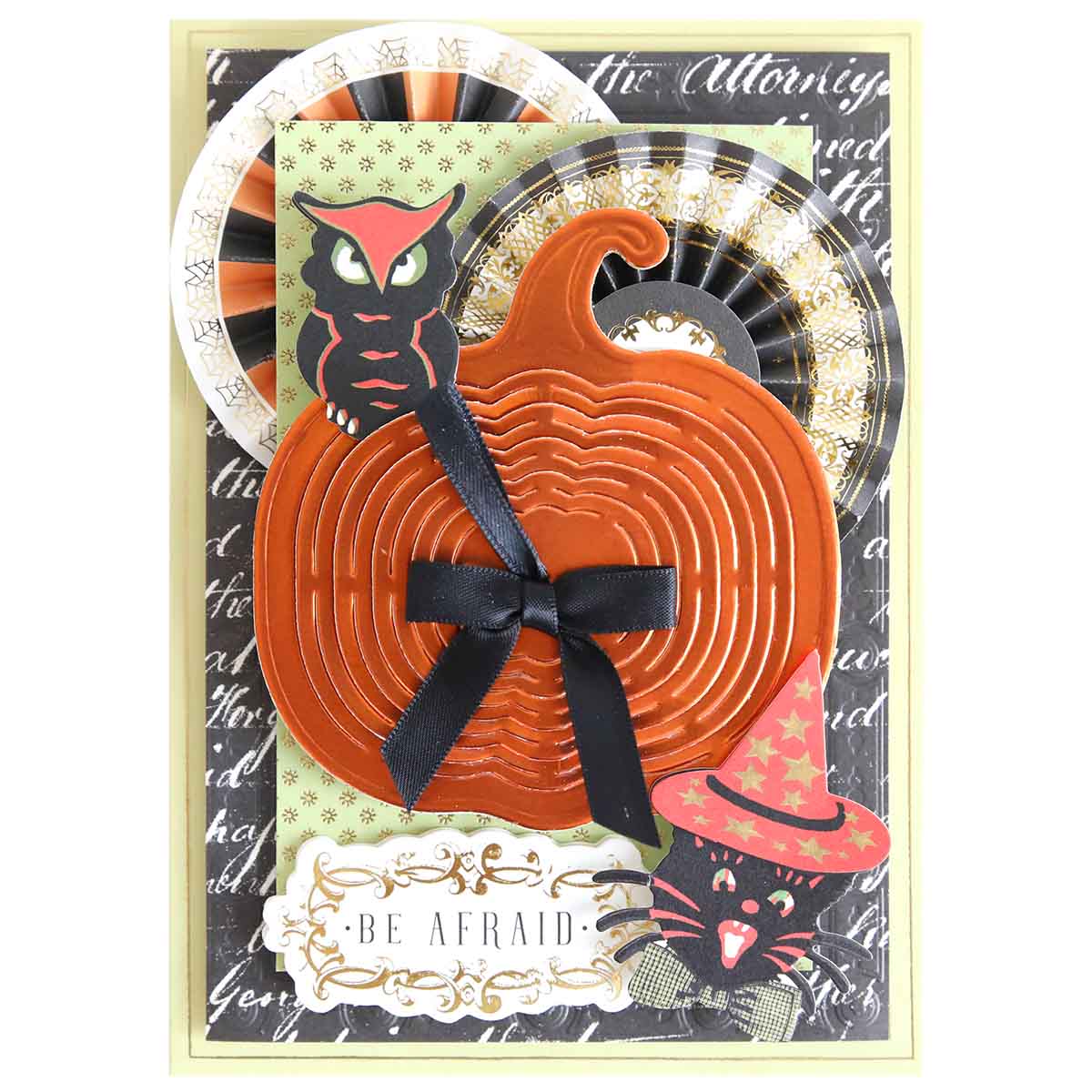 Handmade Halloween card featuring a layered orange pumpkin using Pumpkin Patch Kirigami Dies and Foil Cardstock, black ribbon, owl, witch-hat cat, rosettes, and “Be Afraid” text.