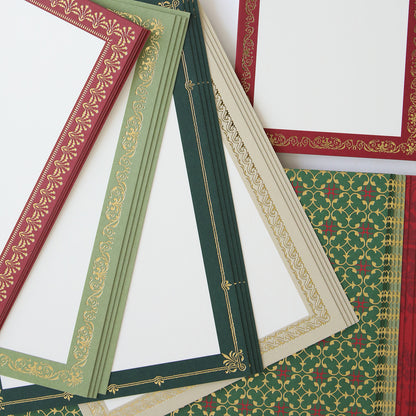 Simply Noel Mini Album features assorted decorative papers with intricate gold border designs in shades of red, green, and beige, arranged in a scattered manner—perfect for creating a Christmas scrapbook kit to cherish family traditions.