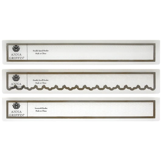 Three Anna Griffin Scroll Work 12" Cut and Emboss Folders are displayed in a row, each showcasing distinct decorative edges labeled "Double Scroll Border" and "Innovative Border.