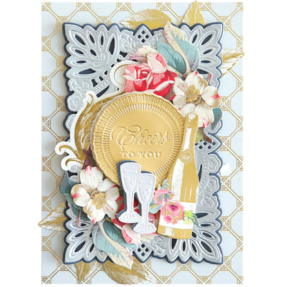 Introducing the "Celebrations 3D Embellishment Dies," an ornate greeting card featuring a gold medallion with "Cheers to You," two champagne glasses, a champagne bottle, and floral decorations on a patterned background—perfect for any birthday or anniversary celebration.