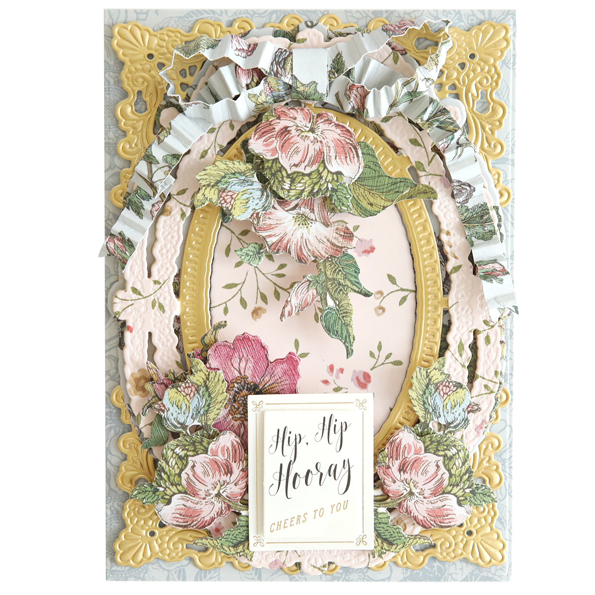 A decorative card featuring pink and white floral designs, gold embellishments, and a message reading "Hip, Hip Hooray Cheers to You," adorned with layered ornate borders and 3D stickers from the Wildflower Meadow collection.