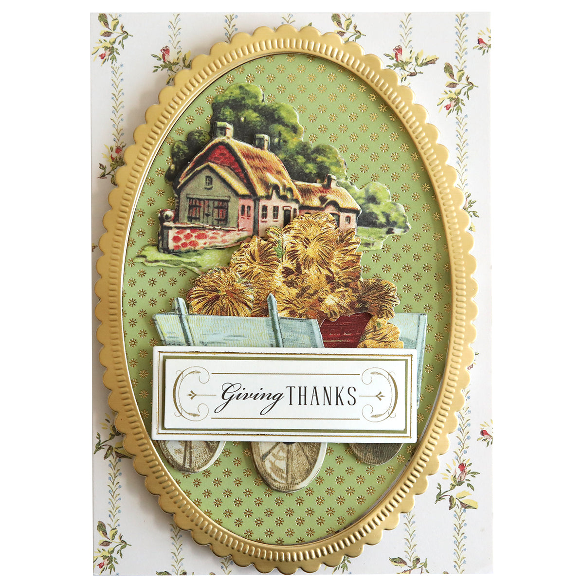 An oval frame card, accented with gold trim for a rustic charm, features a cottage background with a cart filled with hay and a "Giving Thanks" message at the forefront. The background is beautifully decorated with a floral pattern enhanced by Harvest Embellishment Stickers for added dimension.