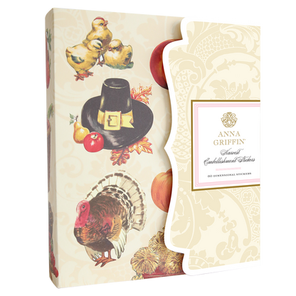 A package of "Harvest Embellishment Stickers" features Thanksgiving-themed designs, including a turkey, fruits, and a pilgrim hat, all exuding rustic charm. These stickers add a touch of seasonal elegance to any project.