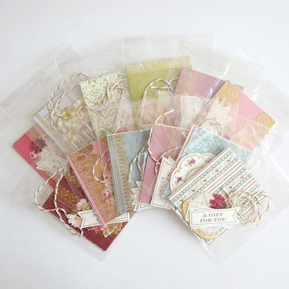 Creative Birthday Tags and Dies: decorative gift tags featuring vintage floral patterns, gold accents, and twine ties in plastic sleeves, with labels reading “A Gift For You” and “Just For You.”