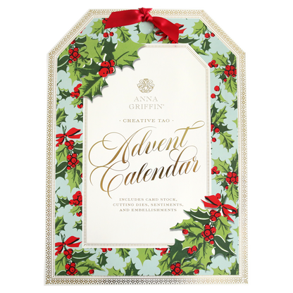 Advent calendar packaging decorated with green leaves, red berries, and red bows, labeled "Creative Tags Advent Calendar," and includes card stock, cutting dies, sentiments, and embellishments.