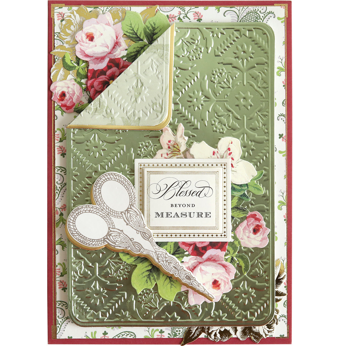 A decorative card created with Quilted Layer Cut & Emboss Folders, showcasing a green embossed background with intricate floral designs, quilted layers, an ornate pair of scissors, and text in the center that reads, "Blessed Beyond Measure.