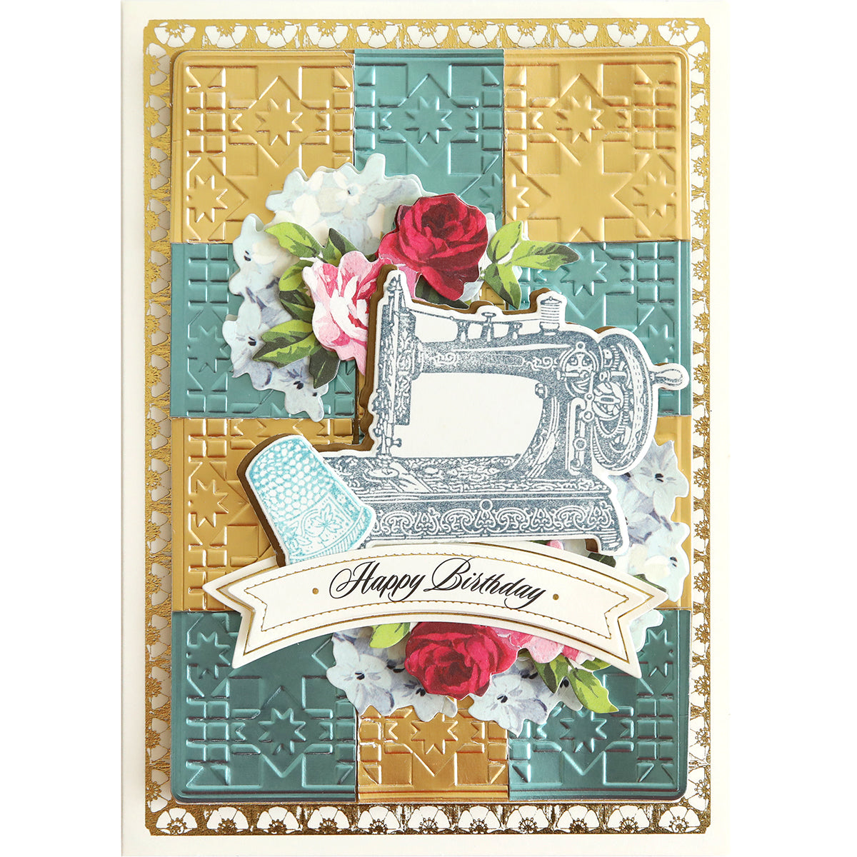 A beautifully crafted card featuring quilted layers and a vintage sewing machine graphic, adorned with flowers and a "Happy Birthday" banner at the bottom. Its borders boast intricate gold accents, skillfully enhanced by the precision provided by Quilted Layer Cut & Emboss Folders.