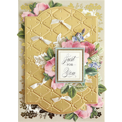 A decorative card featuring a gold embossed design with pink flowers and greenery, crafted using the Quilted Layer Cut & Emboss Folders, with the text "Just for You" beautifully displayed in an ornate frame on the front.