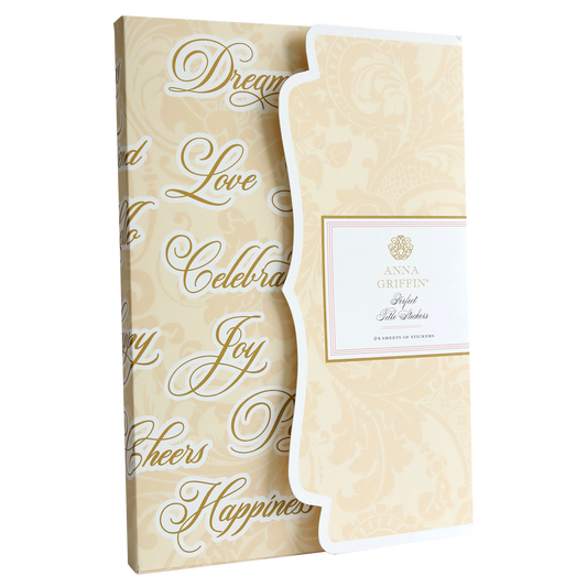 A cream-colored box with decorative text contains 24 sheets of stickers from Anna Griffin, titled "Perfect Title Stickers," perfect for embellishing scrapbook pages.