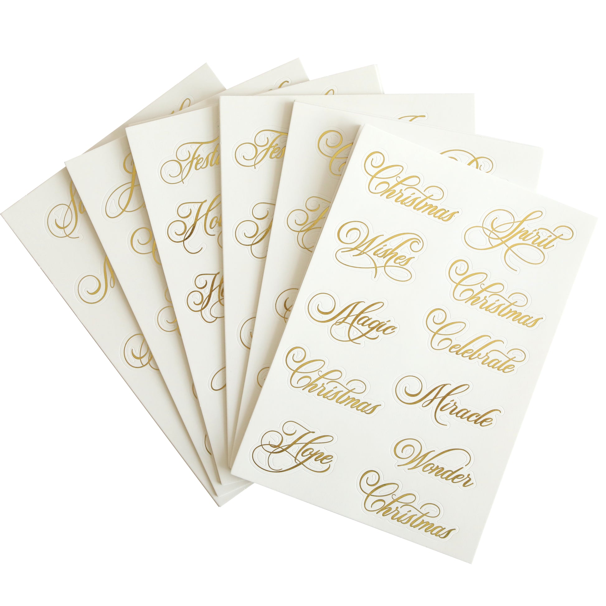 The Perfect Holiday Title Stickers, featuring words like "Christmas," "Magic," "Wonder," and "Hope" in elegant gold calligraphy on white sheets, are ideal for holiday cards or scrapbook pages.