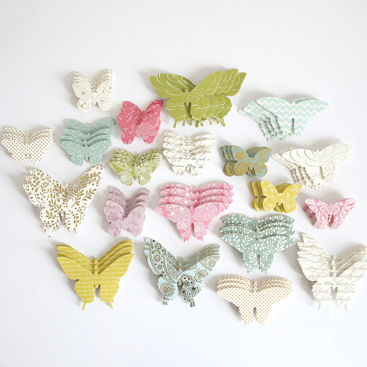 Paper Butterfly Embellishments are elegantly arranged on a white surface, showcasing a delicate display of paper artistry.