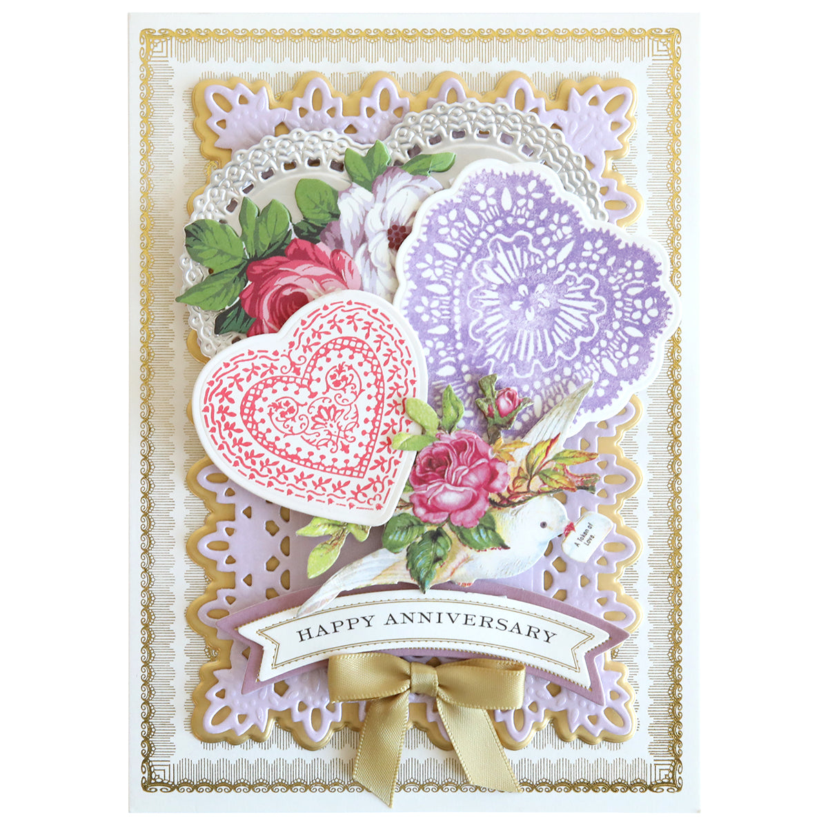 An elegant anniversary card designed with Smitten Stamps and Dies showcases intricate lace patterns, a heart, roses, and a gold bow. With "Happy Anniversary" beautifully written at the center, it makes an ideal craft piece for celebrating love.