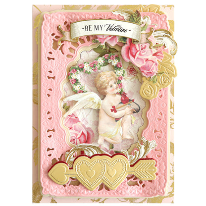 A Smitten Cut Emboss Folders Valentine's Day card showcasing a cherub holding an embossed heart with arrow details, surrounded by roses and adorned with decorative gold accents.