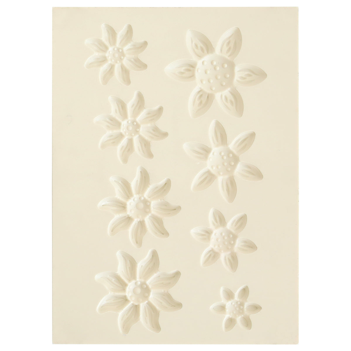 The Blooms Flower Mold, Stamps and Dies set features a white sheet with eight embossed flower shapes in various sizes and petal styles, ideal for crafting dimensional paper flowers using coordinating stamps or the shaping mold.