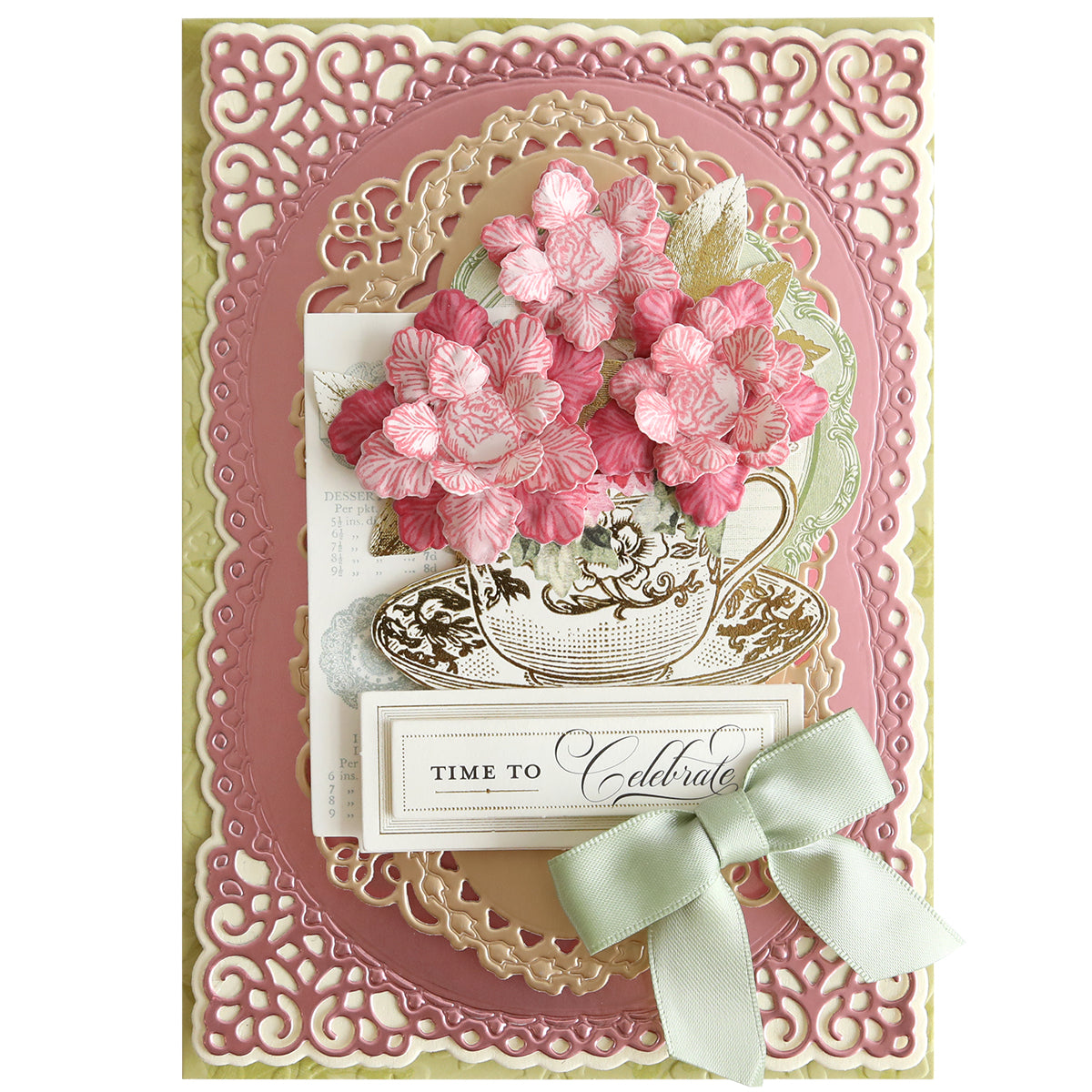 A decorative greeting card with ornate pink and gold borders features a teacup with pink flowers made using the Posies Flower Mold, Stamps and Dies, a "Time to Celebrate" message, and a pale green bow.
