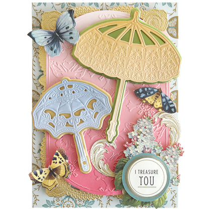Decorative card showcasing ornate parasols, butterflies, and a pink-and-gold background on Ombre Double Sided Cardstock with floral accents and a round "I treasure you" label—ideal for elegant paper crafts.