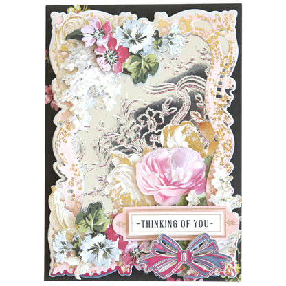 Decorative card on Luxury Mirror Foil Cardstock with ornate embossed borders, featuring pink and white flowers, a butterfly motif, and "Thinking of You" text.